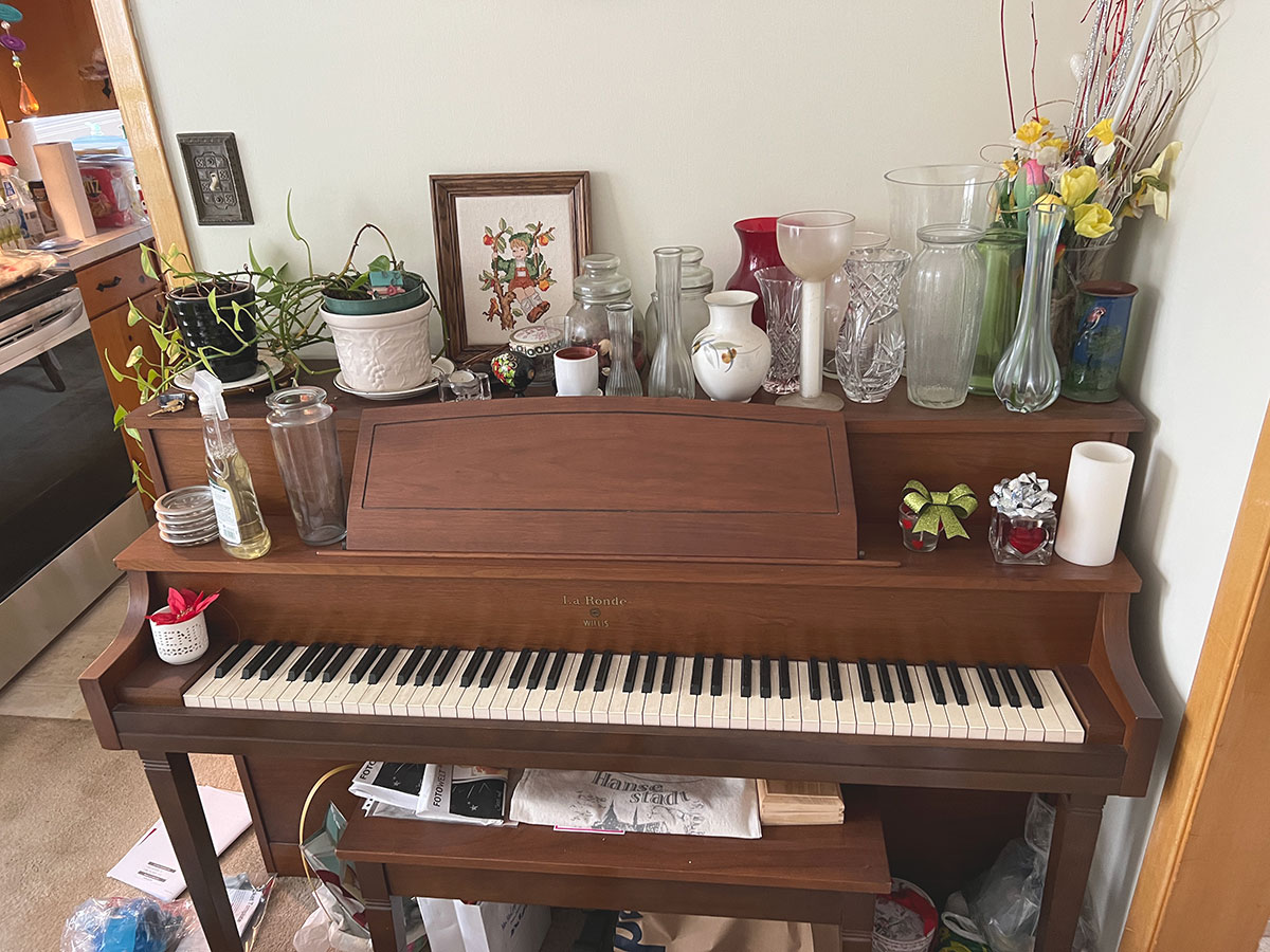 Old piano gathering dust and used as storage