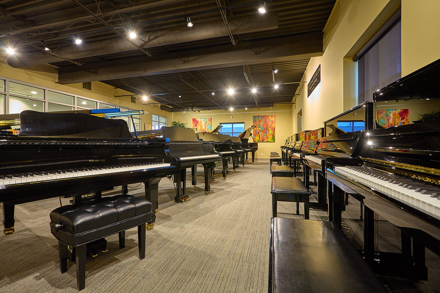 Hulbert piano showroom with upright and grand pianos