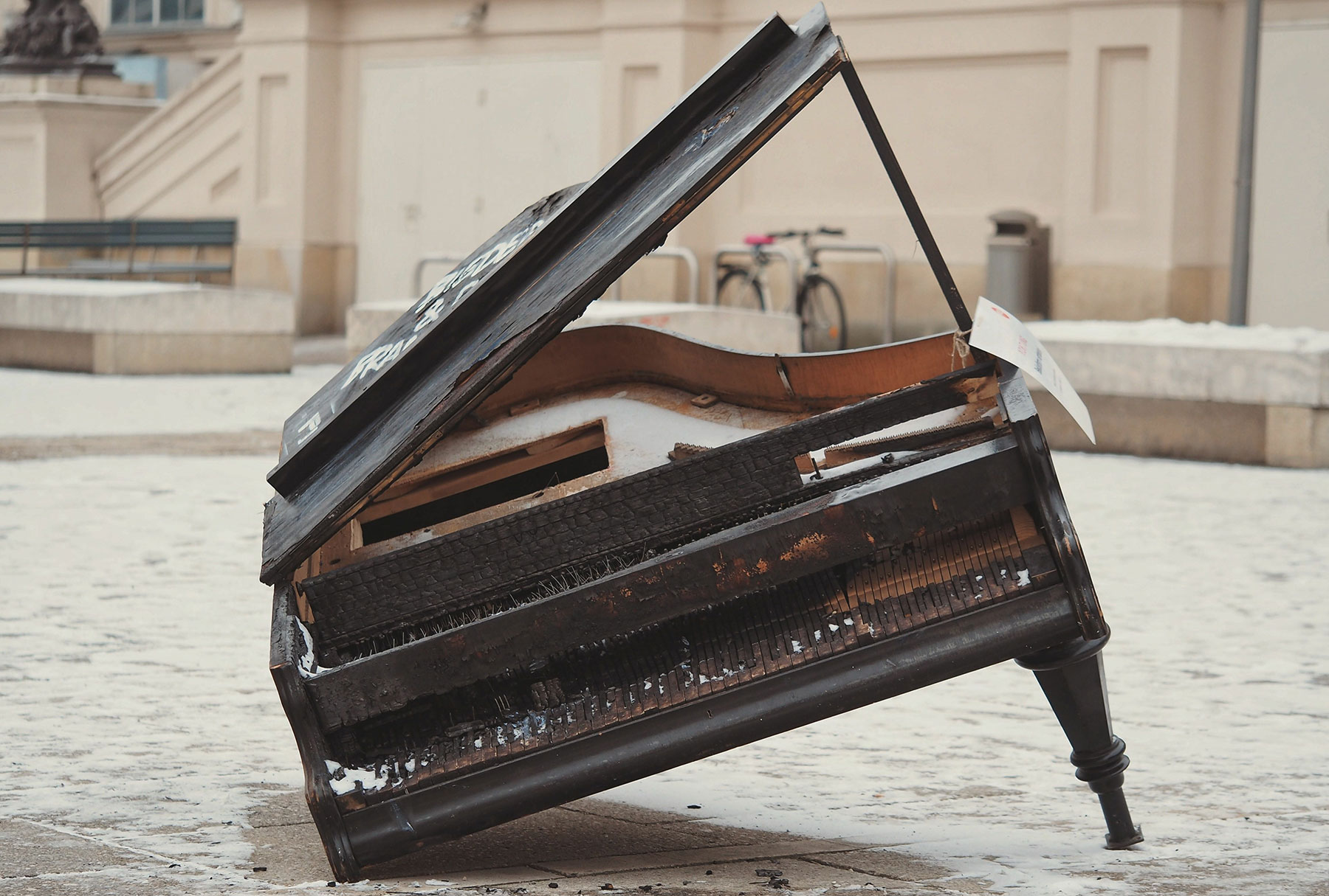 Old, broken-down grand piano on the street