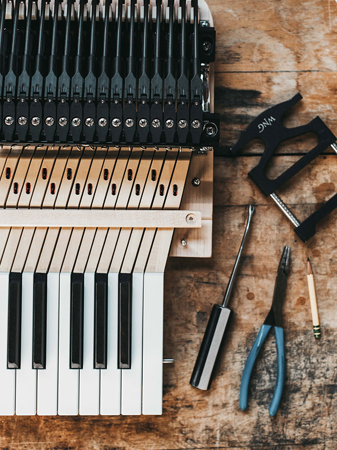 close-up of piano action and service tools