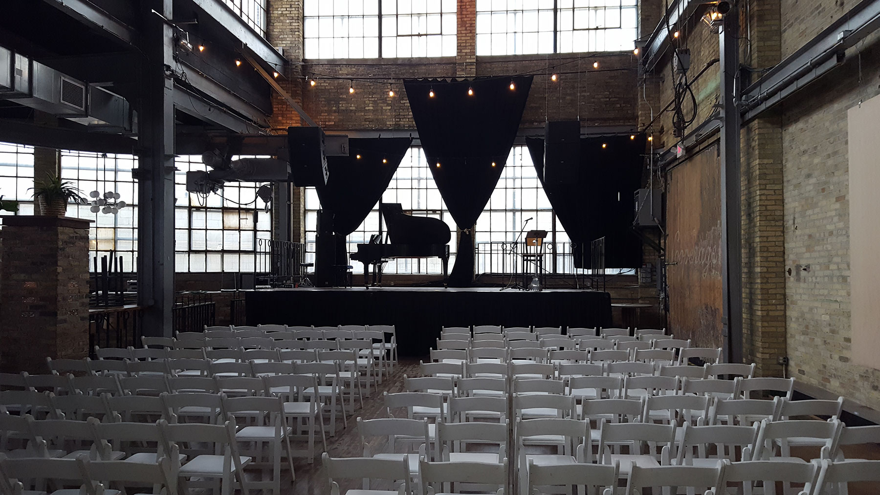 warehouse set up for concert with rented piano